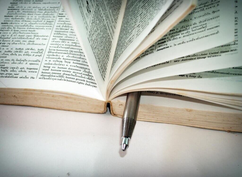 white ballpoint pen on book pages