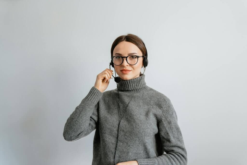 photo of a woman holding the microphone of her headset